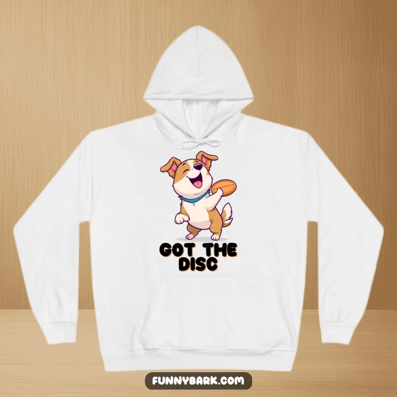 Funny dog hoodie depicting a jubilant dog with a frisbee, barking triumphantly after an amazing catch, radiating pure comedic joy.